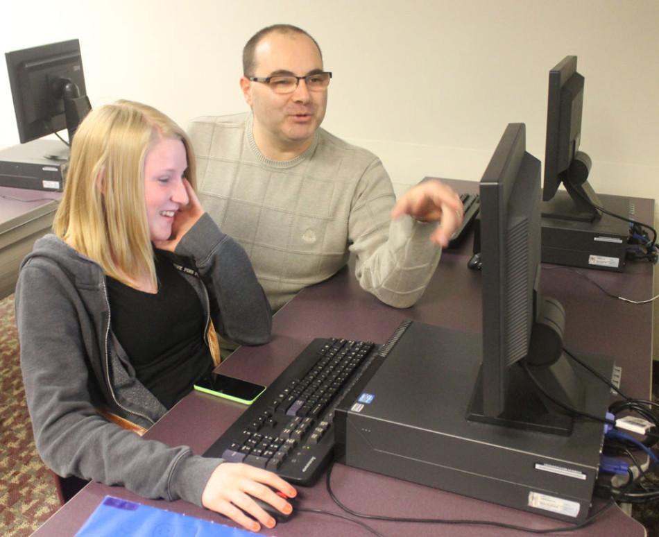 Learning center teacher Adam Gaha works with sophomore Patience Gentry. Gaha was honored as the March You Make a Difference winner.