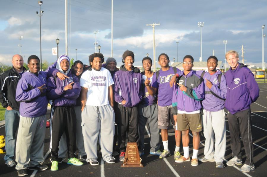 Members of the field events pose with Coach Mike Davidson Thursday night after the Giants won the Marion County track title.