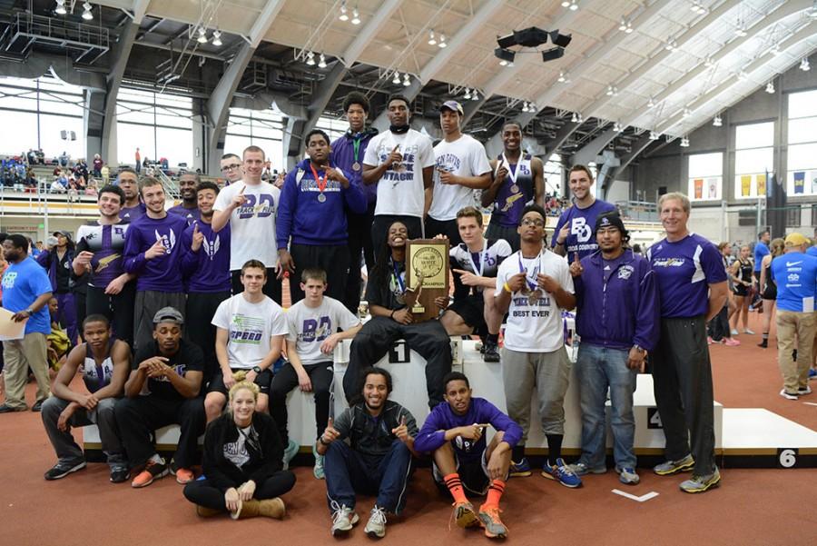 The boys team poses with the state championship trophy Saturday afternoon at Purdue University.