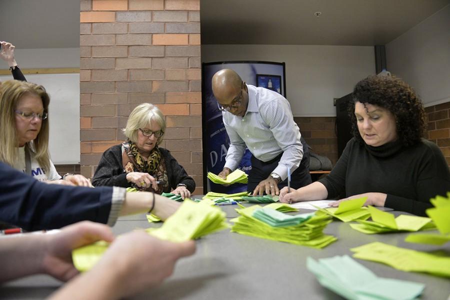 Staff members count ballots at a caucus site in Des Moines, Iowa, on Monday. 