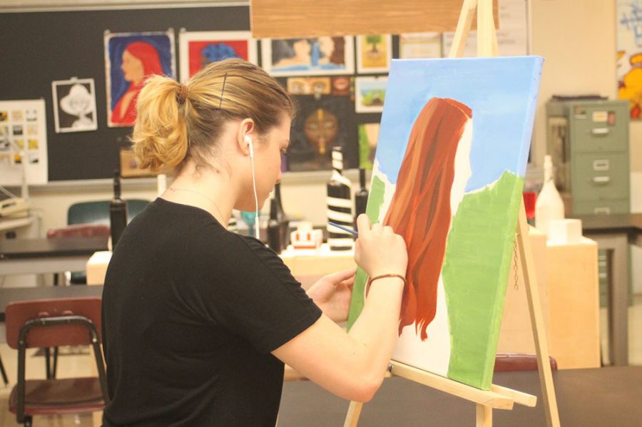 Senior Ashley Trone works on a piece of art while preparing for the SWEAT show this weekend.