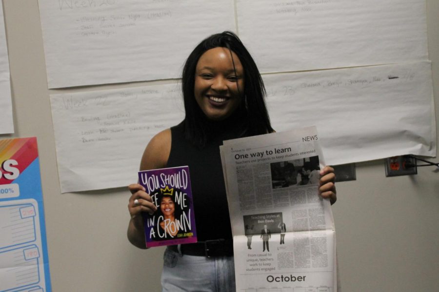 Leah Johnson poses with her first book You Should Me in a Crown and her first article in the Spotlight during a visit to Ben Davis last year.