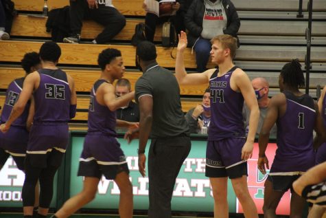 Coach Don Carlisle and his Giants get pumped up during a 77-48 win at Lawrence North earlier this week. The Giants play Pike in the Marion County Final Four tonight at Southport.