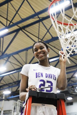 Senior Cristen Carter poses with her piece of the net after the lady Giants won the Marion County tournament. Carter was named an Indiana All-Star Tuesday.