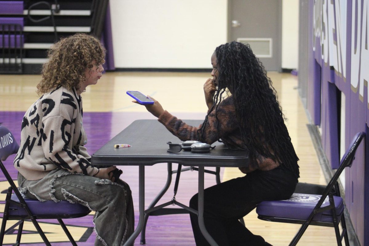 Junior Vana Upshaw talks to a reporter during media day for the girls basketball team.