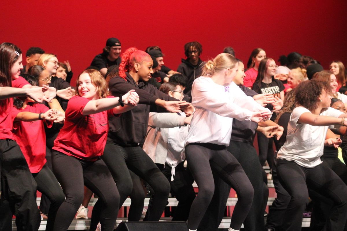 The choir goes through warms up before their performance in Lafayette last weekend. The choir debuts its competition shows Thursday at 7 p.m. in the auditorium.