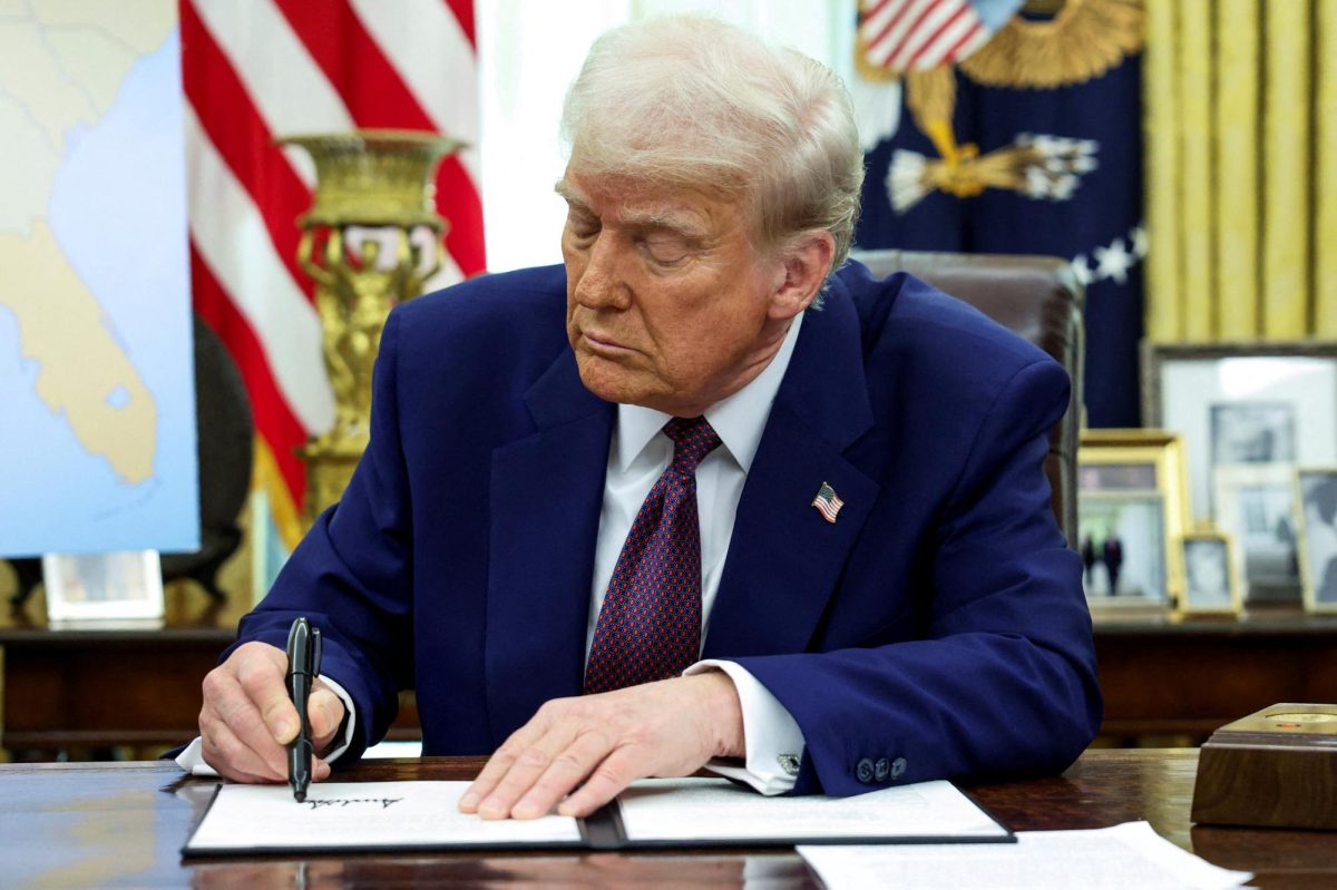 U.S. President Donald Trump signs an executive order about tariffs increase in the Oval Office of the White House in Washington, D.C. on February 13.  (REUTERS/Kevin Lamarque)