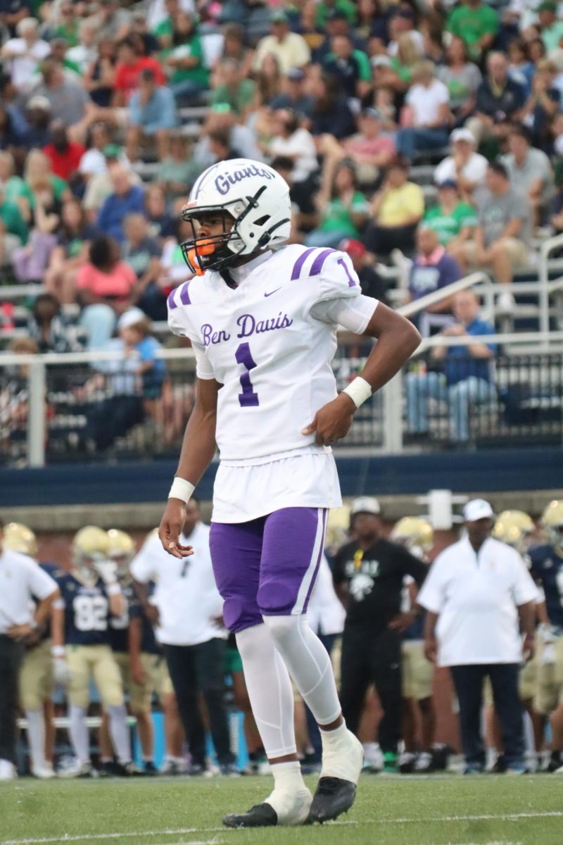 Sophomore quarterback Kenneth Doss looks to the sidelines for a play during last weeks season opener against Cathedral. Doss and the Giants host Avon this Friday at 7 p.m. 