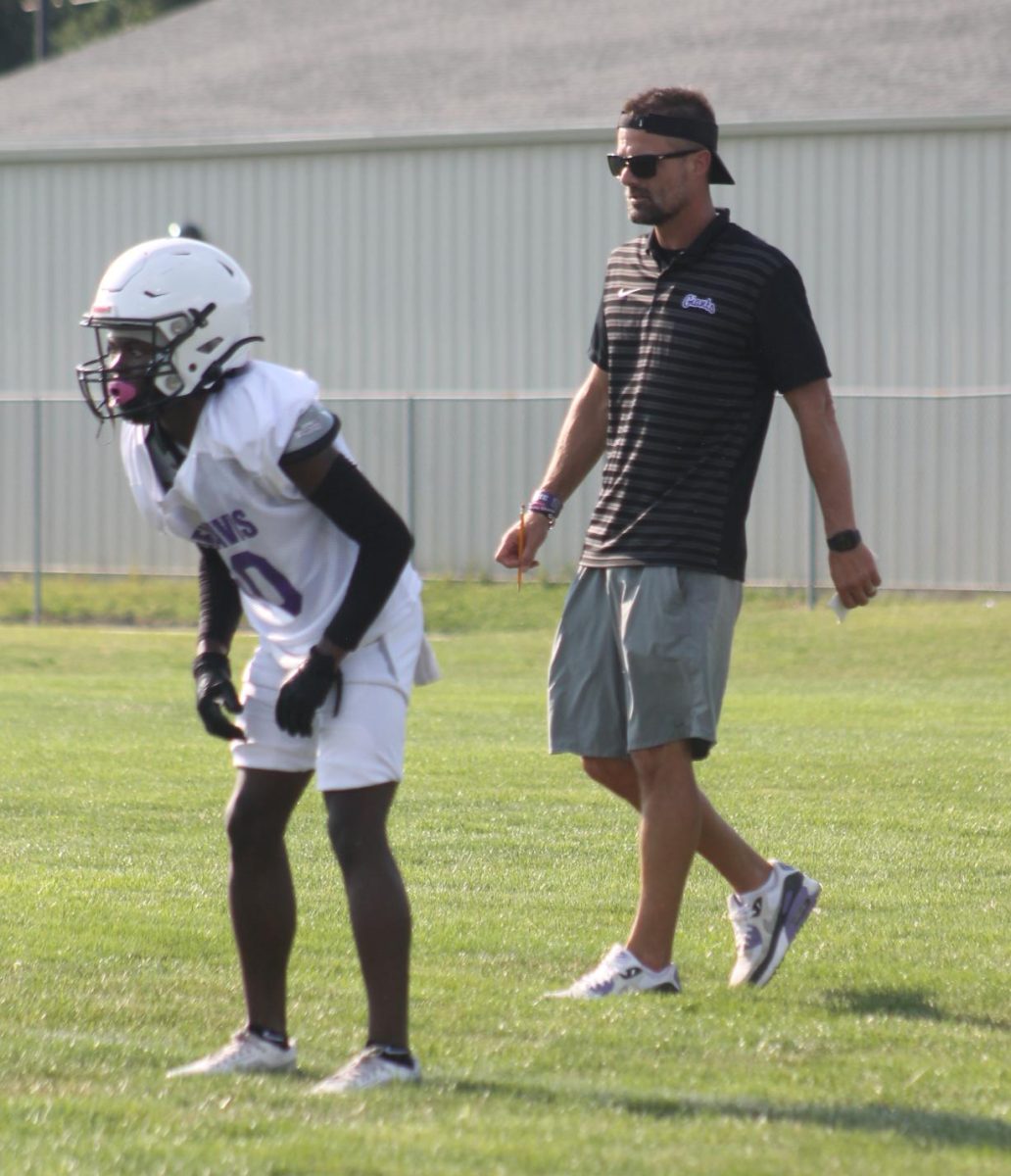 Football coach Russ Mann watches his team during the Purple-White scrimmage this year. Mann resigned Monday after three seasons leading the Giants.